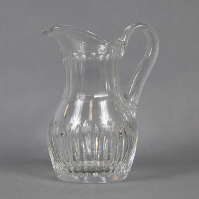 an image of a clear glass pitcher on a gray background