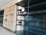 many shelves with bottles of wine on them in a store