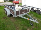 a trailer with a dog in the back of it