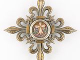 a gold cross with a picture of a person on it