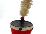 a red and black hat with a feather sticking out of it