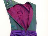 a purple and green dress on a white surface