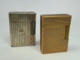 two lighters sitting side by side on a white surface