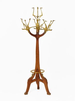 an image of a wooden and brass plated tree on a stand