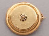 an image of a close up of a gold plated pocket watch