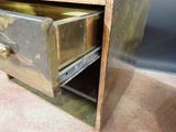 a small metal cabinet with a drawer inside of it