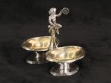 pair of silver plated candlesticks with a lady holding a tennis racquet