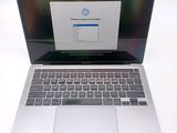 a laptop computer that is open on a white table