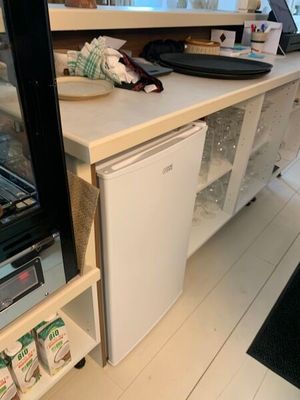 un petit réfrigérateur posé sur un plan de travail