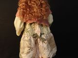 a figurine of a little girl with long red hair