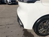 a white car parked in a parking lot with other cars in the background
