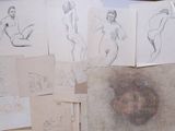 many sketches of a woman sitting on a table