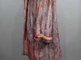 a woman ' s fur coat on a mannequin stand