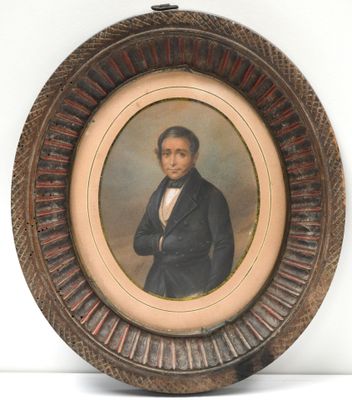 portrait of a man in a black suit and bow tie in a wooden frame