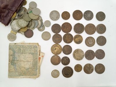 a lot of coins and a wallet on the table