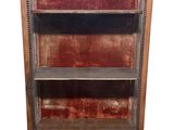 a tall wooden bookcase with many books on it