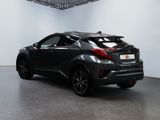 the rear end of a black toyota c - hr in a showroom