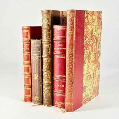 plusieurs vieux livres sont empilés sur une surface blanche