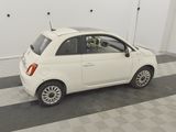 a small white car that is parked in a garage