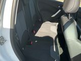 a small car with the door open on the side of the road