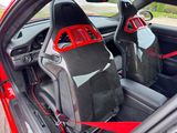 two seats in the back of a car with red trims