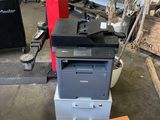 a printer sitting on top of a stack of boxes
