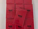 a pile of red books sitting on top of a white table