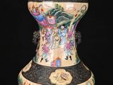 a large vase with a painting on it on a black background