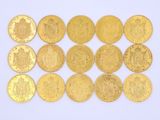 several gold coins are arranged in a row on a white surface