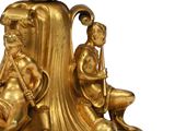 a gold statue of a man and a woman sitting on a table