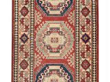 a red and blue rug with geometric design on a white background