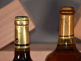 two bottles of wine sitting next to each other on a table
