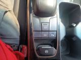 a close up of a car ' s center console with a remote control