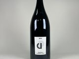la bouteille de vin est posée sur une surface blanche