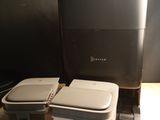 two trash cans sitting next to a printer on a table