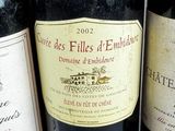 several bottles of wine are lined up on a table