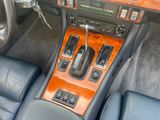a car dashboard with a wooden dash panel and leather seats