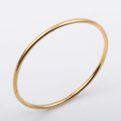 a close up of a gold ring on a white background