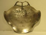 a silver plate with a flower design on it