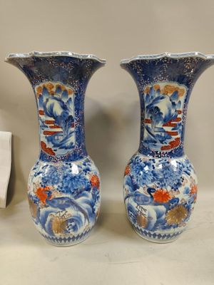 pair of blue and white vases sitting on top of a table
