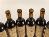 six bottles of wine are lined up in a row on a table
