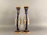 two blue and white vases sitting on a table