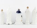several figurines of people are lined up in a row