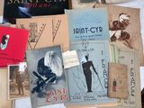 many books on a table with a white table cloth