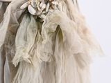 a close up of a woman ' s dress with a flower on it