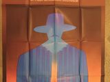 an image of a movie poster with a man in a hat