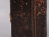 an old book sitting on top of a table next to a white background