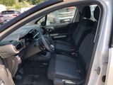 the interior of a car with the door open and the driver ' s seat down