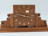 a wooden clock that is sitting on top of a table