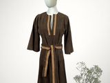 an image of a mannequin wearing a brown robe and a red hat